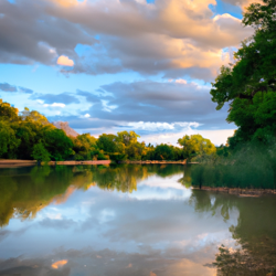 Take a drive along a winding river with a lush forest on one side. Imagine the sun setting, casting a golden hue on the trees and the river's surface. Capture this moment in a romantic landscape painting, with a focus on the vibrant colors of the sky and the reflection of the trees in the water.